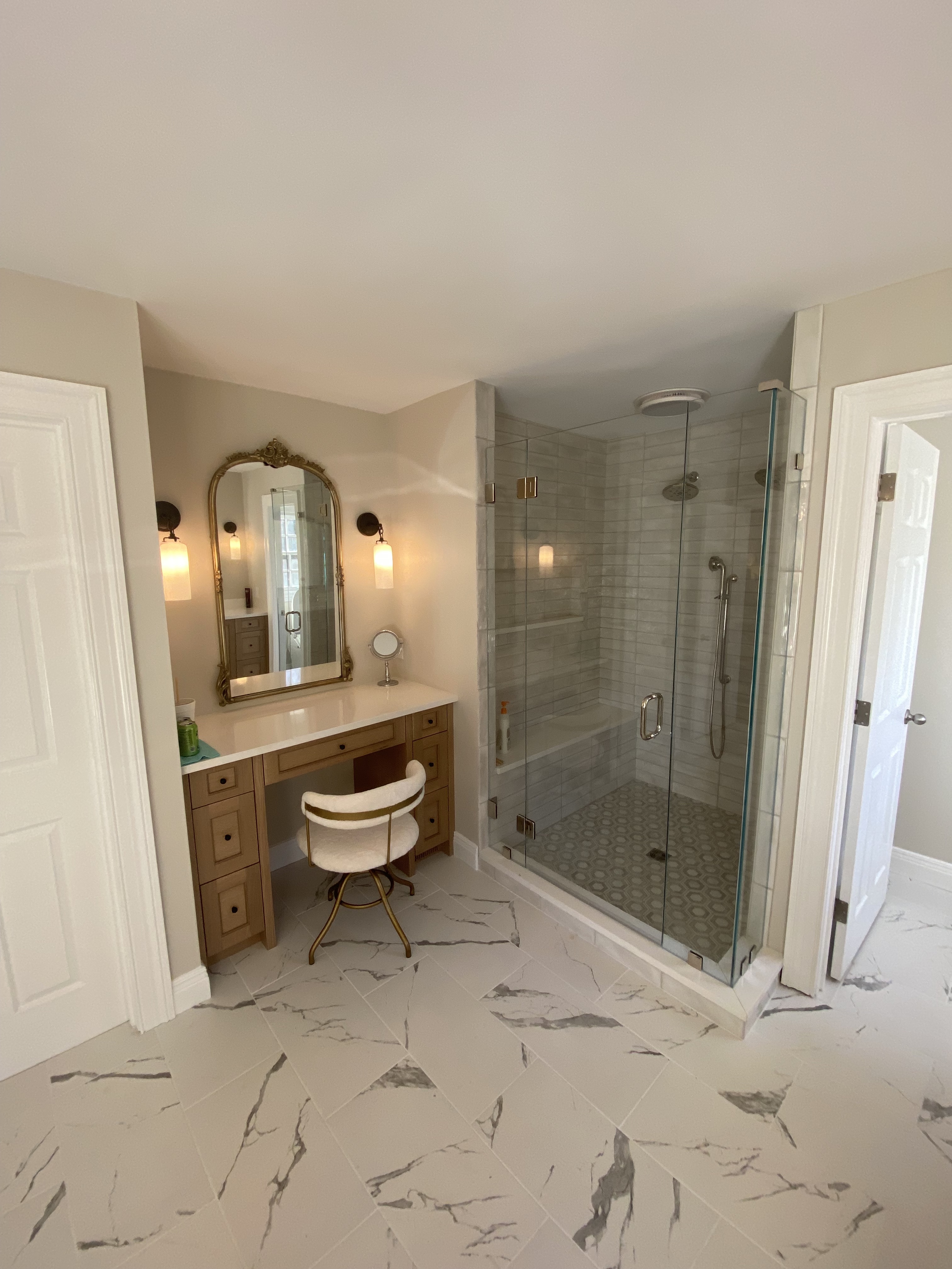 Rolling Hills bathroom — makeup vanity with gold mirror and frameless glass shower by Luxe Built